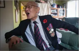  ?? The Canadian Press ?? Second World War veteran Ronald Lee, 98, a Canadian Army sergeant who fought in the British-led Force 136, jokes around while posing for a photograph in Vancouver on Wednesday.