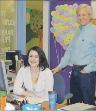  ?? NIKKI SULLIVAN/CAPE BRETON POST ?? Kelsey MacNeil, a program assistant at the Educationa­l Program Innovation­s Charity, works at her Sydney office desk while founder and supervisor Barry Waldman looks on.