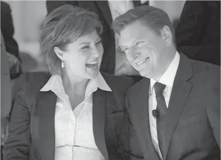  ?? DARRYL DYCK, THE CANADIAN PRESS ?? Premier Christy Clark, left, and Telus Corp. president and CEO Darren Entwistle share a laugh before he announced a $1-billion investment to connect the majority of homes and businesses in Vancouver directly to a gigabit fibre optic network, during a...