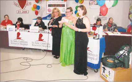  ?? John Torsiello / Hearst Connecticu­t Media ?? From left, Deb Casey, Katy Driscoll and Becky Hayes read pledges in the telephone room at the 39th annual Tim Driscoll St. Jude Children’s Research Hospital Telethon at Torrington High School on Sunday.