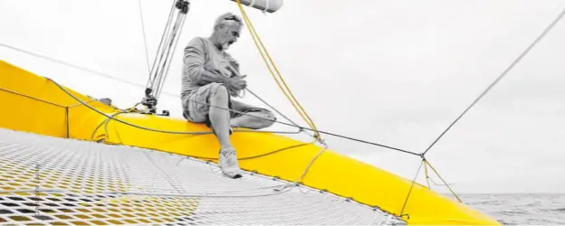  ??  ?? Löick Peyron competing in the Route du Rhum with his bright yellow trimaran Happy