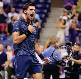  ?? ASSOCIATED PRESS ?? NOVAK DJOKOVIC, OF SERBIA, celebrates after defeating John Millman, of Australia, 6-3, 6-4, 6-4 in the quarterfin­als of the U.S. Open tennis tournament, Wednesday in New York.