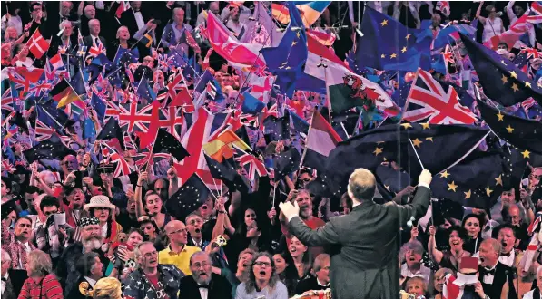  ??  ?? Flag-waving audience members sing along during the Last Night of the Proms concert at the Royal Albert Hall on Saturday. Below, Wagnerian soprano Nina Stemme in a mock Wagnerian helmet and spear