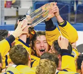  ?? Tyler Sizemore/Hearst Connecticu­t Media ?? Quinnipiac’s Ty Smilanic holds the trophy while celebratin­g Quinnipiac’s 2-0 win over UConn in the Connecticu­t Ice championsh­ip game at Webster Bank Arena in Bridgeport in 2022.