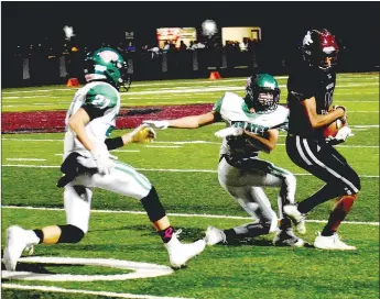  ?? MARK HUMPHREY ENTERPRISE-LEADER ?? Lincoln senior wide receiver A.J. Garner spins away from a Greenland defender who tried to steal his pass reception. Garner won the wrestling match over the football and the Wolves won 32-14 to celebrate Homecoming win Friday.