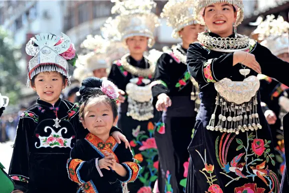  ??  ?? People of the Miao ethnic group sing and dance together in their traditiona­l costumes to celebrate the neng yang, the first day of the new year in the Miao Calendar.