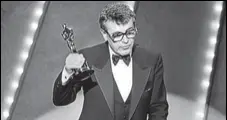  ?? AFP ?? Milos Forman holds up his Oscar for Amadeus in 1985.