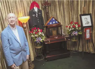  ?? STAFF PHOTO, ABOVE, BY NICOLAUS CZARNECKI; COURTESY PHOTO, LEFT, DEFENSE POW/MIA ACCOUNTING AGENCY ?? FINAL TRIBUTE: Michael Brady stands watch in a Taunton funeral home with the remains of his father, Tech. Sgt. John Brady, who was shot down over Germany near the end of World War II. The elder Brady’s remains were only recently identified.