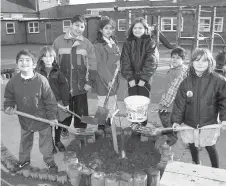  ?? ?? Children from Ellington School planted trees in their playground in 1997. Ref:135075-6