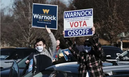  ?? Photograph: John Arthur Brown/ ZUMA Wire/REX/Shuttersto­ck ?? Supporters rally for Democratic Senate candidates Jon Ossoff and Raphael Warnock on 14 December.