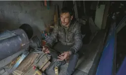  ?? JEFF J. MITCHELL/GETTY ?? A civilian seeks shelter in a garage Friday after his home in Irpin was destroyed. Ukrainian soldiers killed so far number in the tens of thousands, an official said.