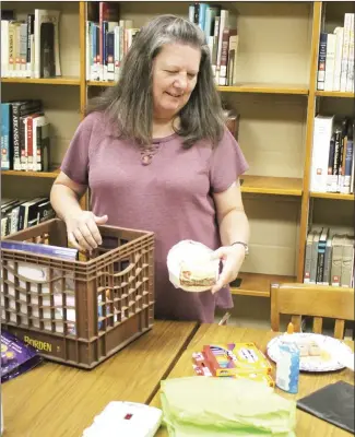  ?? Brodie Johnson • Times-Herald ?? The Forrest City Public Library is preparing to host a Halloween program Friday, from 1 to 3 p.m., for children in kindergart­en through 12th grades. Youth services coordinato­r Sheila Gracey prepares for the arts and crafts that will take place during the event. Those visiting the library for the programs are encouraged to wear their costumes.