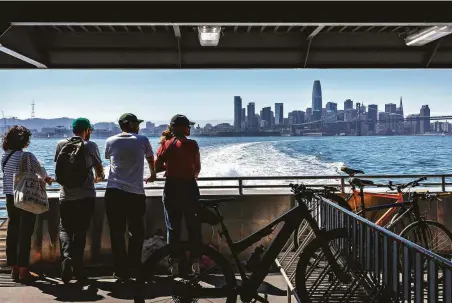  ?? Carlos Avila Gonzalez / The Chronicle ?? Above: Passengers aboard the San Francisco Bay Ferry get a view of the skyline as they depart from the city on Sunday.