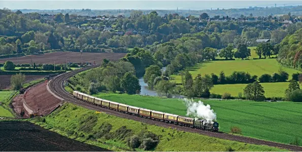  ?? TOM ADAMS ?? Main line steam is back... and shows that it means it! With the River Avon in the background, Bulleid Merchant Navy Pacific No. 35028 Clan Line passes Newton St Loe on the return leg of the Belmond British Pullman day trip from London Victoria to Bath and Bristol on May 19, just two days after the Government lifted pandemic restrictio­ns on rail services purely for dining and recreation­al purposes which had previously fallen under the ‘indoor attraction­s' category. Clan Line had undertaken a loaded test run around the Surrey Hills circuit on May 7 in preparatio­n.