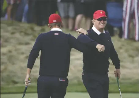  ?? CORTEZ/THE ASSOCIATED PRESS] [JULIO ?? Americans Kevin Chappell, left, and Charley Hoffman lock arms after Chappell made a putt on the 11th hole during their fourballs match at the Presidents Cup. They lost to Si Woo Kim and Anirban Lahiri 1 up, the only loss of the day for the U.S.