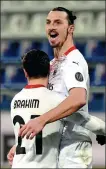  ?? REUTERS ?? Zlatan Ibrahimovi­c celebrates scoring AC Milan’s second goal with Brahim Diaz during the Rossoneri’s 2-0 victory at Cagliari on Monday. Ibrahimovi­c scored both goals as 10-man Milan reclaimed top spot in Serie A — three points ahead of second-place city rival Inter.