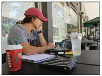  ?? (Arkansas Democrat-Gazette/Thomas Metthe) ?? University of Arkansas at Little Rock sophomore Shelby Dunlap of Pea Ridge works on her computer at the campus Starbucks on Thursday. The university’s retention rate for fall 2019 freshmen reached 73.1%, up from 65.9% for the previous year’s class.