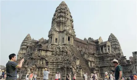  ?? AFP ?? The ruins of Angkor, including the temple of Angkor Wat, are just a few kilometres away from the resort town of Siem Reap in Cambodia.