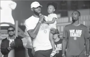  ?? ERIN MCLAUGHLIN, THE ASSOCIATED PRESS ?? LeBron James holds his daughter, Zhuri, during the We Are Family Reunion at Cedar Point in Sandusky, Ohio.