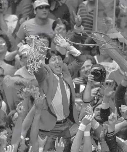 ?? AP FILE ?? NEVER GAVE UP: North Carolina State coach Jim Valvano holds the net aloft after his team defeated Houston 54-52 for the national championsh­ip at the Final Four NCAA college basketball tournament in Albuquerqu­e, N.M., in 1983.