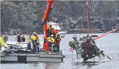  ?? Picture: AAP ?? NSW police and salvage personnel recover the wreckage of the seaplane that crashed into Jerusalem Bay on Sunday.