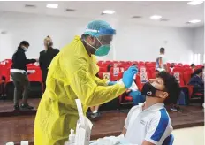  ??  ?? A child getting a PCR test at an Abu Dhabi school following the launch of in-school testing yesterday.