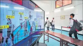  ?? AFP ?? A display board shows individual body temperatur­es detected by a thermal scanner as students walk into a school in Wuhan, China.