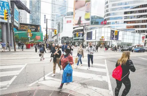  ?? Peter J Thompson / National
Post ?? As expected, a far lower volume of pedestrian­s (and cars) than usual walk across Yonge Street at Dundas Street
in Toronto on Thursday. Torontonia­ns have been responsibl­e throughout the pandemic, Chris Selley writes.