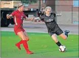  ?? [SARAH PHIPPS/THE OKLAHOMAN] ?? Oklahoma State's Camy Huddleston passes the ball as Oklahoma's Olivia Smith defends during the Bedlam soccer match last August at Neal Patterson Stadium in Stillwater.