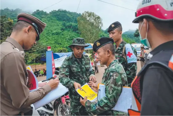  ?? Picture: GETTY IMAGES ?? Non-essential personnel are ordered to leave the cave site and surroundin­g roads as the rescue operation swings into action yesterday.