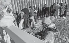  ?? Elliot Spagat / Associated Press ?? A Cuban and her daughter wait for processing in Yuma, Ariz. The U.S. is allowing unaccompan­ied children to seek asylum.