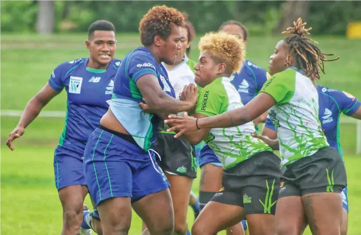  ?? Photo: ?? Rooster Chicken Fijiana Drua prop Mereoni Vonosere (left) tussles for the ball against Rhino Rugby Academy during their friendly match at Prince Charkes Park, Nadi, on March 15, 2023.