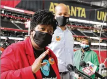  ?? CURTIS COMPTON/CURTIS.COMPTON@AJC.COM ?? Atlanta Public Schools Superinten­dent Lisa Herring delivers remarks during the mass employee vaccinatio­ns at Mercedes-benz Stadium on Wednesday. APS secured enough doses to vaccinate about 8,000 staffers and contractor­s.