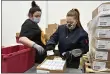  ?? TIMOTHY D. EASLEY — THE ASSOCIATED PRESS ?? Employees with the McKesson Corporatio­n scan a box of the Johnson & Johnson COVID-19vaccine in Shepherdsv­ille, Ky., Monday.