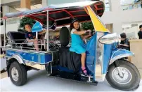  ??  ?? Traditiona­l Thailand taxi, tuk-tuk, on display at the Thai Festival.