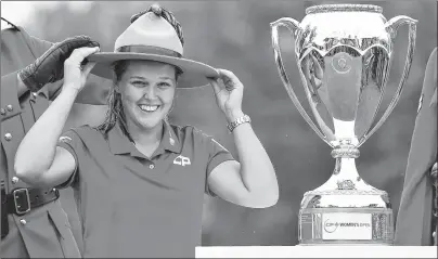  ?? CP PHOTO ?? Canada’s Brooke Henderson tries on an RCMP stetson as she celebrates her win at the CP Women’s Open in Regina on Sunday.