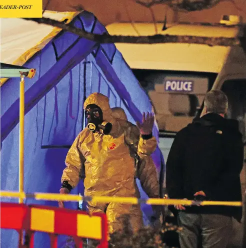 ?? STEVE PARSONS/PA VIA THE ASSOCIATED PRESS ?? Investigat­ors work at the scene in Salisbury, England, where a former Russian double agent and his daughter were attacked with a nerve agent. As the pair fight for their lives, the U.K. government pledged a “robust” response if suspicions of Russian...