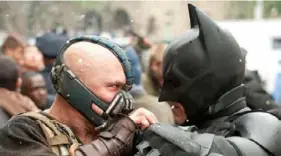  ?? Ron Phillips ?? Tom Hardy, left, portrays Bane and Christian Bale is Batman in "The Dark Knight Rises,” shot partially in Pittsburgh. The 2012 movie will be shown April 17 at the Carrie Furnaces.