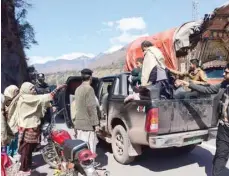  ?? — AFP ?? Residents evacuate from the border town of Chakothi in Pakistan-administer­ed Kashmir, some 3 km from Line of Control, on Wednesday.