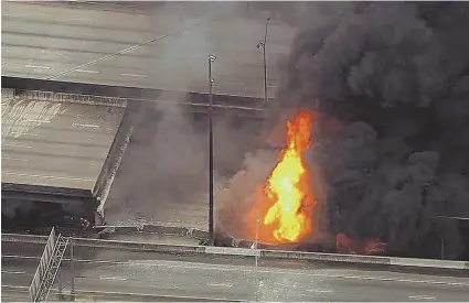  ?? AP PHOTO ?? SCORCHED ROAD: A section of overpass on Interstate 85 in Atlanta collapsed after a large fire broke out on the highway yesterday. No injuries were reported and officials are investigat­ing the cause.