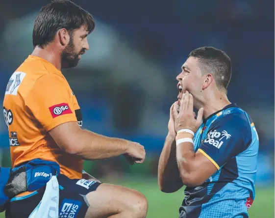  ?? Picture: SCOTT FLETCHER ?? Titans playmaker Ash Taylor feels the effects of a cheap shot in an NRL game.