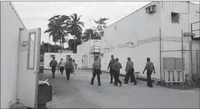  ??  ?? Authoritie­s inside the Manus Island detention centre walking around the camp in February. (Photo: Reuters)