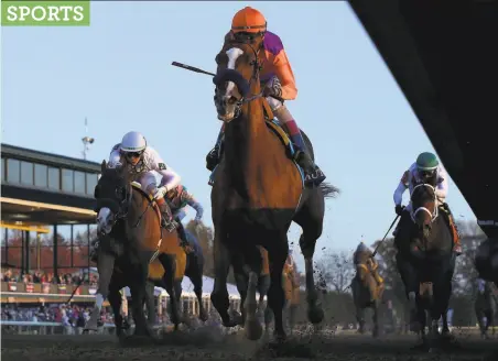  ?? Andy Lyons / Getty Images ?? Authentic, with John Velazquez aboard, runs to victory in the Breeders’ Cup Classic at Keeneland in Lexington, Ky.