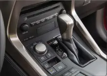  ??  ?? The center stack/console is very busy with buttons, switches, knobs, a shift lever, a dial clock and a touchy track pad that controls the screen functions. We would suggest you not fiddle with this while driving, at least until you get used to it.
