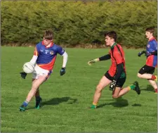  ??  ?? Coláiste Eoin’s Billy Lawlor tries to launch an attack.