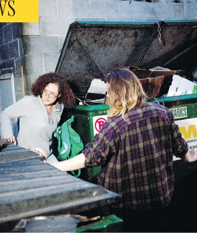  ?? CHAD HIPOLITO / POSTMEDIA NEWS ?? University of Victoria students Emily Kirbyson, left, and Rebecca Rogerson “dumpster dive” behind a grocery store.