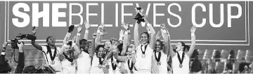  ?? — AFP photo ?? Team France celebrates with the trophy after defeating the United States of America 3-0 to win the SheBelieve­s Cup at RFK Stadium in Washington, DC.
