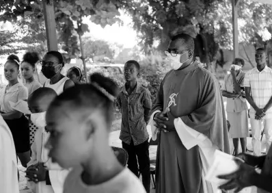  ?? AP ?? Catholic priest Jean-Nicaisse Milien walks to give a Mass in Port-au-Prince, Haiti, on Sunday. He was kidnapped for 20 days along with other priests, nuns, and civilians in April by the 400 Mawozo gang who have been holding 17 members of a US-based missionary group Christian Aid Ministries for more than three weeks.