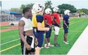  ?? DAVID FURONES/STAFF PHOTO ?? Junior Shaun Shivers, left, watches Chaminade’s first spring practice from the sideline. The 2016 Player of the Year is preparing for this weekend's state track meet, where he will compete in the 100- and 200-meter races in Class 2A.