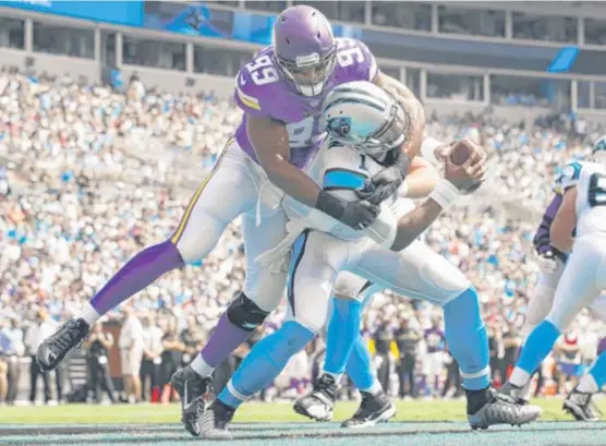  ?? | AP ?? The Vikings held down Cam Newton, intercepti­ng the leagueMVPt­hree times and sacking him eight times, one of those resulting in a safety by Danielle Hunter ( above).